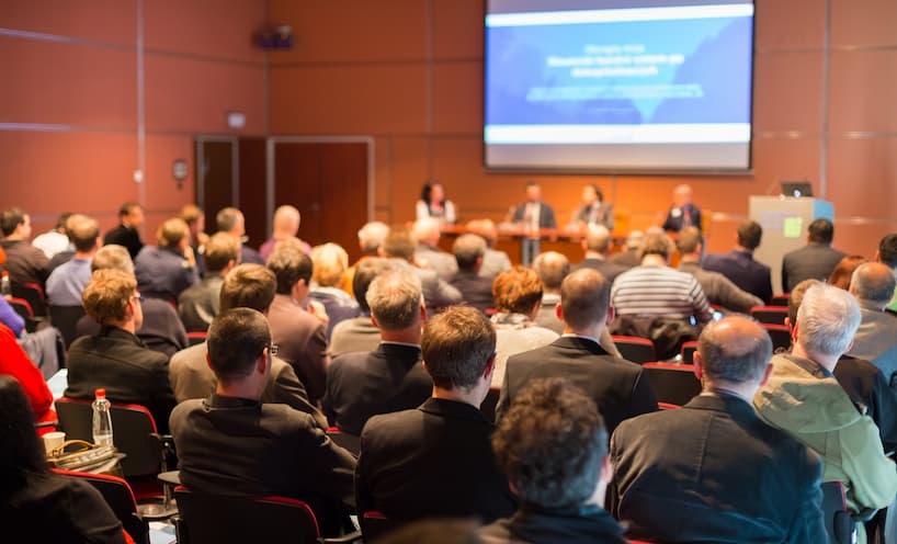 A group pf people in a conference