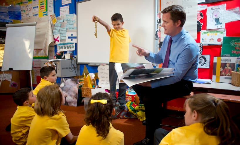 Image of a teacher with students in a classroom