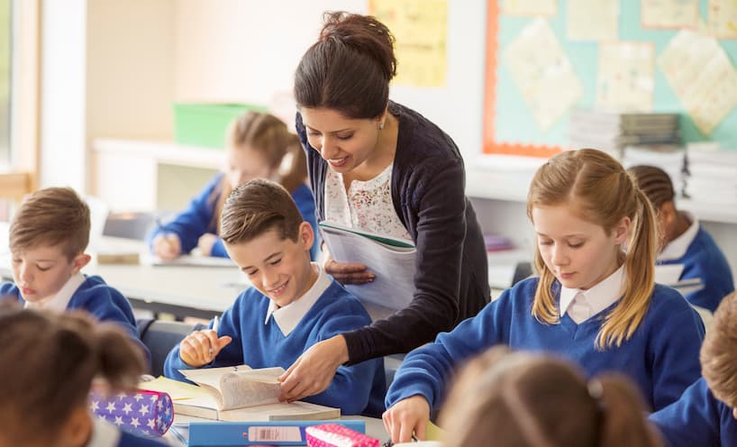 Image of a teacher with students in a classroom