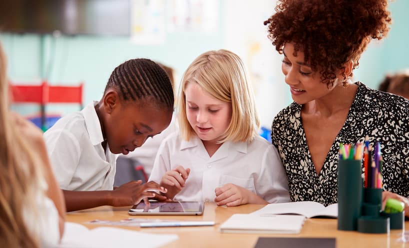 Image of a teacher helping students