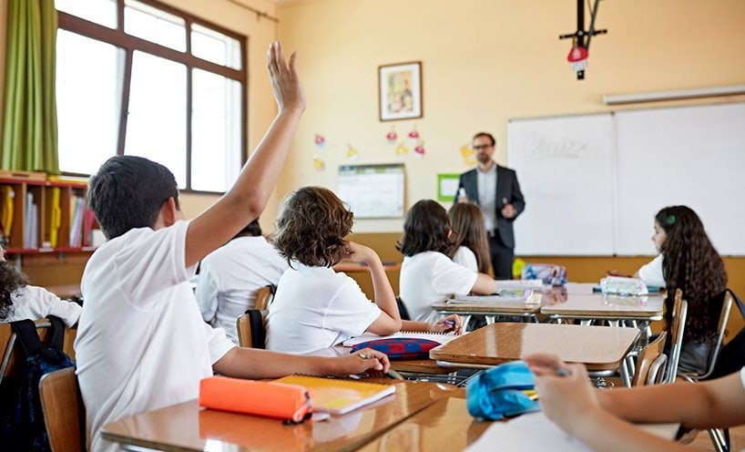 Group of school students and teacher in a classroom