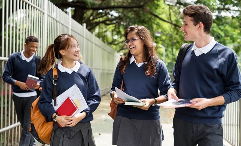 A group of college students talking and laughing